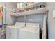 Functional laundry room with washer, dryer, and open shelving for storage at 1848 Winthrop Se Dr, Atlanta, GA 30316