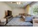 Bright living room with plush seating, a ceiling fan, and a large window overlooking the outdoors at 1848 Winthrop Se Dr, Atlanta, GA 30316