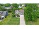 Aerial view of a well-manicured home with mature trees, lush landscaping, and a spacious driveway at 3635 Bardfield Ct, Cumming, GA 30041