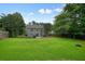 Expansive backyard featuring a large lawn, mature trees, and a deck perfect for outdoor entertaining at 3635 Bardfield Ct, Cumming, GA 30041