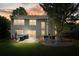 Backyard featuring a patio and deck, illuminated by warm lighting during sunset, creating a cozy atmosphere at 3635 Bardfield Ct, Cumming, GA 30041