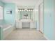 Spacious bathroom featuring a double vanity, large tub, and neutral tile flooring at 3635 Bardfield Ct, Cumming, GA 30041