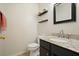 Powder room features granite counters, updated faucet, and modern dark wood cabinets at 3635 Bardfield Ct, Cumming, GA 30041