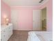 Cozy bedroom features lots of natural light, neutral carpet, and a cheerful pink color at 3635 Bardfield Ct, Cumming, GA 30041