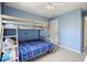 bedroom showcasing a bunk bed, window, ceiling fan, and blue wall color at 3635 Bardfield Ct, Cumming, GA 30041