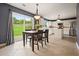 Dining area with outside access, views of the backyard, and a beautifully updated kitchen at 3635 Bardfield Ct, Cumming, GA 30041