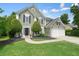 Inviting two-story home with a well-maintained lawn, two-car garage, and welcoming front entrance at 3635 Bardfield Ct, Cumming, GA 30041