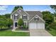 Charming two-story home featuring a well-maintained lawn, a two-car garage, and classic architectural details at 3635 Bardfield Ct, Cumming, GA 30041