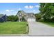 Beautifully landscaped front yard and two-car garage enhance the curb appeal of this two-story home at 3635 Bardfield Ct, Cumming, GA 30041