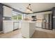 Bright eat-in kitchen features stainless steel appliances, white cabinets, and a center island at 3635 Bardfield Ct, Cumming, GA 30041
