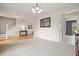 Well-lit living room space showcasing neutral walls, decorative wall trim, and hardwood flooring at 3635 Bardfield Ct, Cumming, GA 30041
