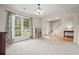 Bright living room with lots of natural light from the big windows, modern chandelier, and storage at 3635 Bardfield Ct, Cumming, GA 30041