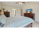 Main bedroom with large window, ceiling fan, wood furnishings and light-colored walls at 3635 Bardfield Ct, Cumming, GA 30041