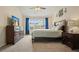 Main bedroom with large window, ceiling fan, wood furnishings and light-colored walls at 3635 Bardfield Ct, Cumming, GA 30041
