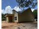 Side view of a single-story yellow home with a gray roof and covered porch at 103 New Home Rd, Rockmart, GA 30153