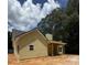 Side view of a single-story yellow home with a gray roof and covered porch at 103 New Home Rd, Rockmart, GA 30153