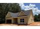 Angle view of a single-story yellow home with a gray roof and an attached garage at 103 New Home Rd, Rockmart, GA 30153