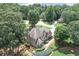Captivating aerial view of a home surrounded by lush greenery, beautiful landscaping and nearby neighborhood at 1720 Monarch Ct, Cumming, GA 30041