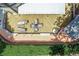 An aerial view shows a spacious wooden deck featuring a dining area and lounge chairs in an outdoor setting with mature trees at 1720 Monarch Ct, Cumming, GA 30041