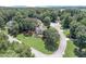 Aerial view of home on large, lushly wooded lot in a suburban neighborhood at 1720 Monarch Ct, Cumming, GA 30041