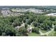 Aerial view showcases the home amidst mature trees in suburban community at 1720 Monarch Ct, Cumming, GA 30041