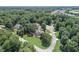 Aerial view of a property nestled among mature trees in a peaceful, upscale neighborhood at 1720 Monarch Ct, Cumming, GA 30041