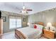 Comfortable bedroom with a ceiling fan, large window, and coordinating furnishings at 1720 Monarch Ct, Cumming, GA 30041