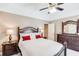 Bedroom featuring neutral paint, ceiling fan and dark wood furnishings at 1720 Monarch Ct, Cumming, GA 30041