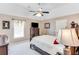 Bedroom with ceiling fan, large bed, and dresser with television at 1720 Monarch Ct, Cumming, GA 30041