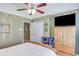 Bedroom featuring a ceiling fan and a large armoire for ample storage space at 1720 Monarch Ct, Cumming, GA 30041