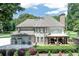Lush backyard with a covered deck area, offering a serene outdoor retreat for relaxation or entertaining guests at 1720 Monarch Ct, Cumming, GA 30041
