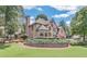 Well-maintained two-story brick home featuring a lush green lawn and mature trees at 1720 Monarch Ct, Cumming, GA 30041