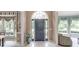 Welcoming foyer with tile flooring, arched doorway, and views into adjacent living spaces showcasing natural light at 1720 Monarch Ct, Cumming, GA 30041