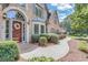 Inviting front entrance featuring a decorative wreath, brick walkway, and manicured shrubbery at 1720 Monarch Ct, Cumming, GA 30041