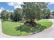 Expansive front lawn with well-maintained landscaping, mature trees, and a circular driveway at 1720 Monarch Ct, Cumming, GA 30041