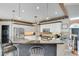 This spacious kitchen features white cabinets, stainless steel appliances, and a granite countertop island at 1720 Monarch Ct, Cumming, GA 30041