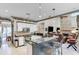 Open kitchen featuring white cabinets, stainless steel appliances, granite counters, and access to the living room at 1720 Monarch Ct, Cumming, GA 30041