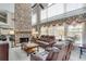 Spacious living room with a stone fireplace, high ceilings, and multiple windows at 1720 Monarch Ct, Cumming, GA 30041