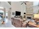 Open concept living room featuring a stone fireplace and a view of the staircase at 1720 Monarch Ct, Cumming, GA 30041
