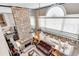 Grand living room with a floor-to-ceiling stone fireplace and large windows at 1720 Monarch Ct, Cumming, GA 30041