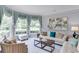 Bright living room with bay window, decorative curtains, and neutral furniture at 1720 Monarch Ct, Cumming, GA 30041