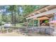 Outdoor bar area with grill, countertop space, TV, and seating, perfect for entertaining and enjoying the outdoors at 1720 Monarch Ct, Cumming, GA 30041