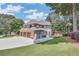 Back exterior with large patio and deck and well-kept lawn with trees providing privacy at 1720 Monarch Ct, Cumming, GA 30041