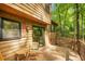 View of back deck featuring a patio table, railings, and access to a grassy backyard with tall trees at 2269 Sparrow Ridge Ne Dr, Marietta, GA 30066