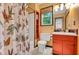 Bathroom with colorful vanity, unique shower curtain, and neutral tile floors at 2269 Sparrow Ridge Ne Dr, Marietta, GA 30066