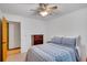 Bedroom features blue bedding, wood floors, and a ceiling fan at 2269 Sparrow Ridge Ne Dr, Marietta, GA 30066