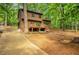 Exterior view of house with lush trees, back deck, and outdoor bench seating at 2269 Sparrow Ridge Ne Dr, Marietta, GA 30066