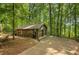 A detached garage with two bays and a long driveway surrounded by a lush tree canopy at 2269 Sparrow Ridge Ne Dr, Marietta, GA 30066