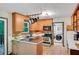 Charming kitchen with wood cabinets, stainless steel appliances, and a convenient laundry area at 2269 Sparrow Ridge Ne Dr, Marietta, GA 30066
