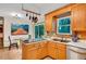 Kitchen with wood cabinets, stainless steel sink, and a view of the dining area and backyard at 2269 Sparrow Ridge Ne Dr, Marietta, GA 30066